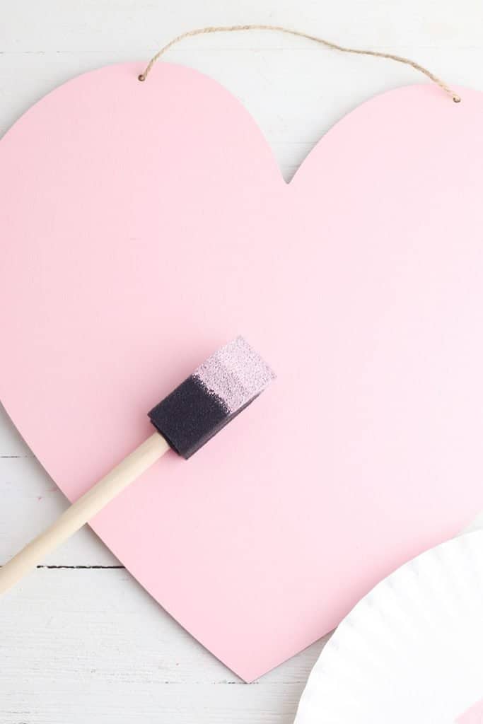 painting wooden heart pink for valentine's DIY decor craft