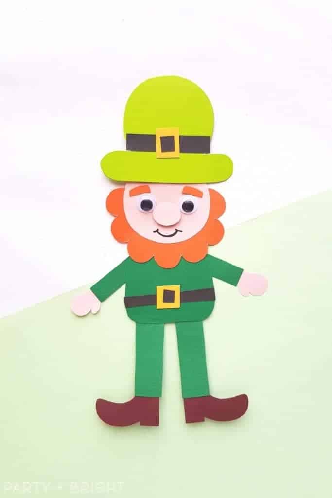 cute leprechaun paper puppet made from printable template on a white and green background