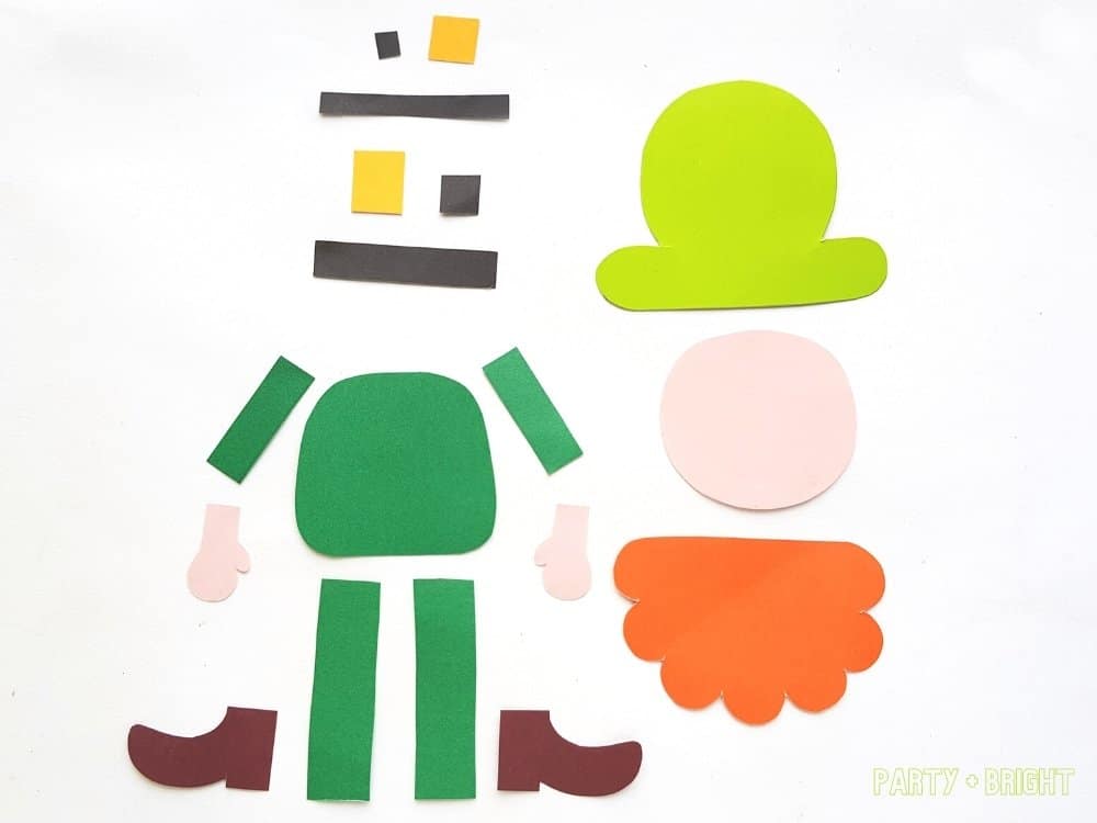 pieces cut from template of leprechaun in colored paper