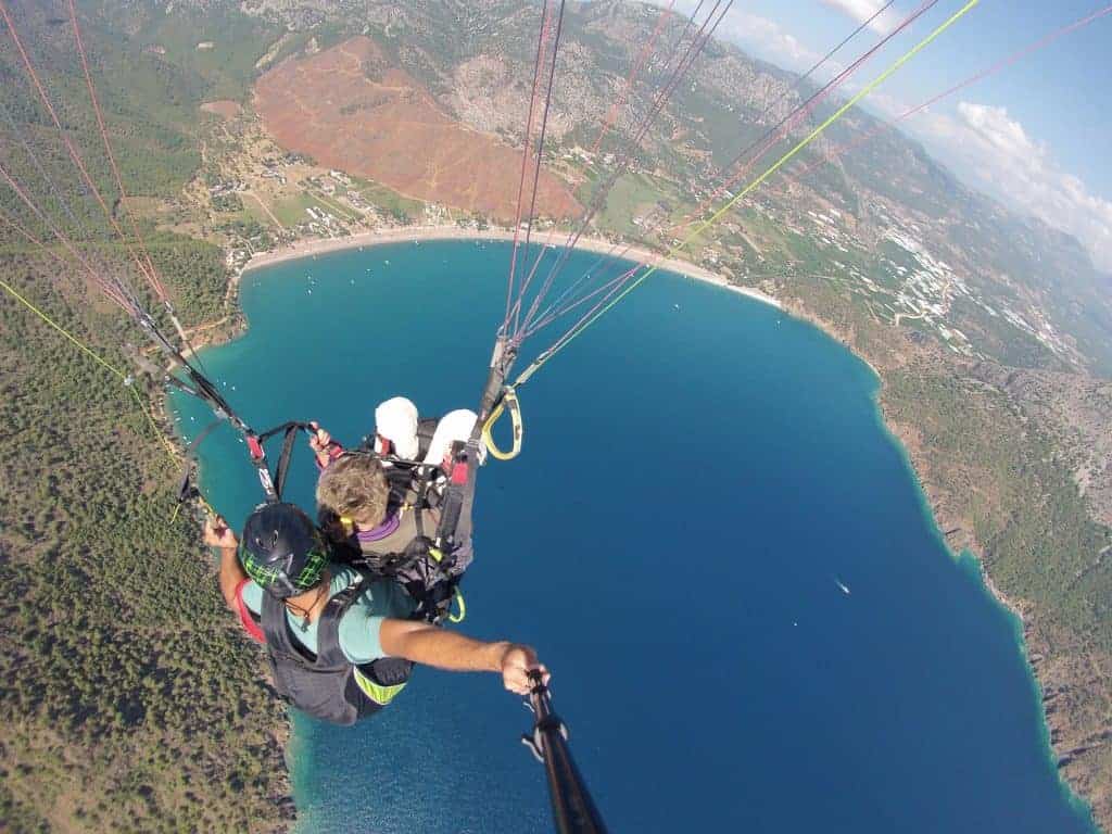 Skydiving instructor with senior student skydiving over coast