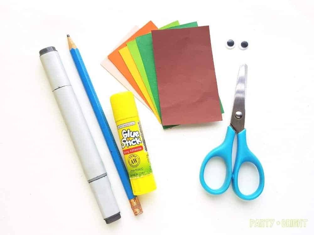 supplies for a paper leprechaun craft spread out on white background