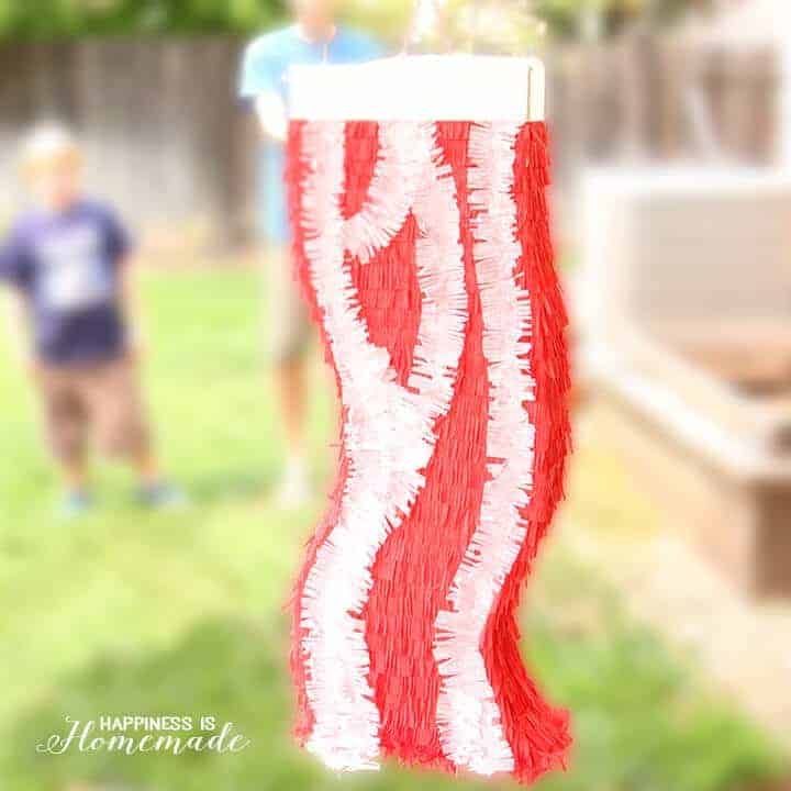 funny bacon pinata hanging with people in the background