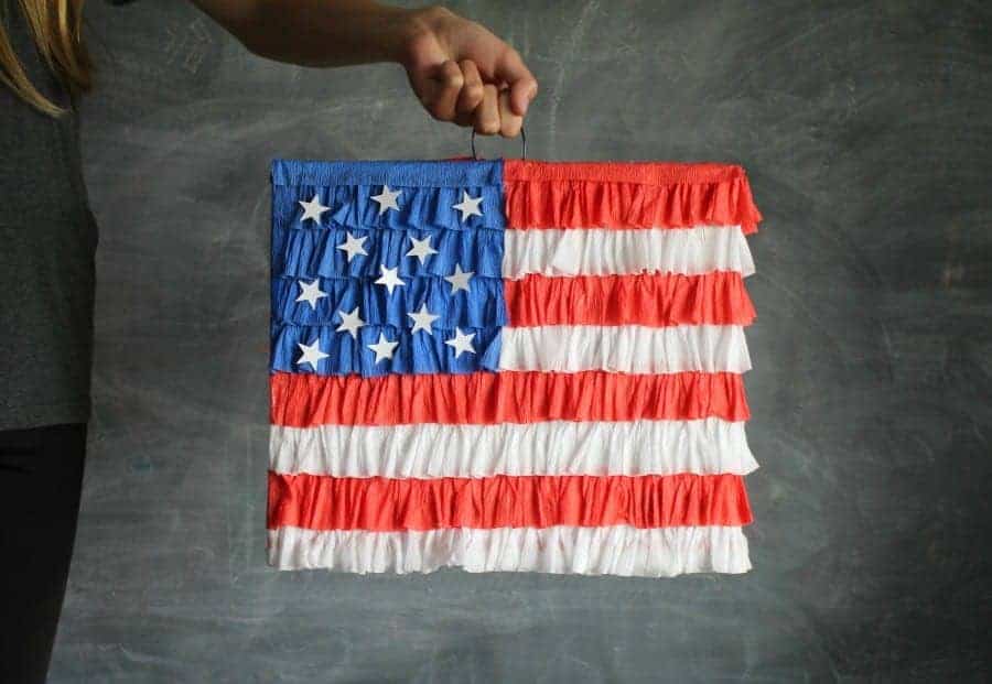 red white and blue flag pinata being held by a hand