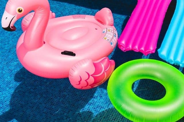 brightly colored pool floats in swimming pool