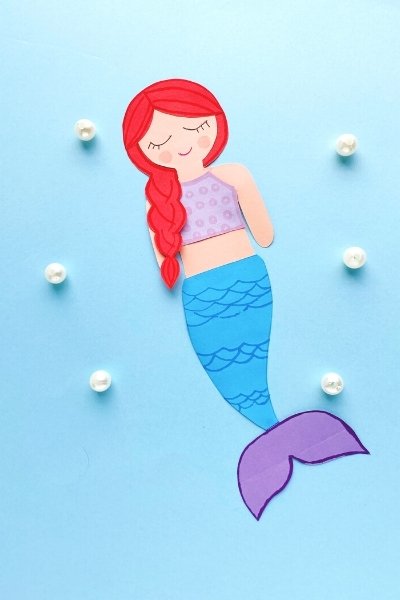 mermaid paper craft made from printable template on a blue background with pearls