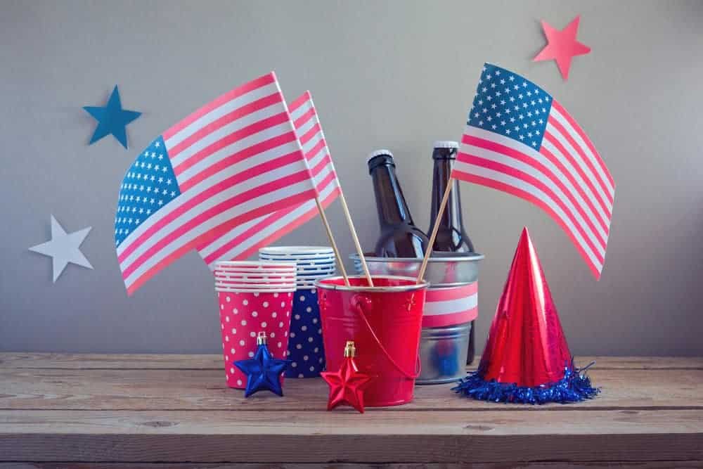 4th of july centerpiece with small metal buckets and american flags with patriotic cups