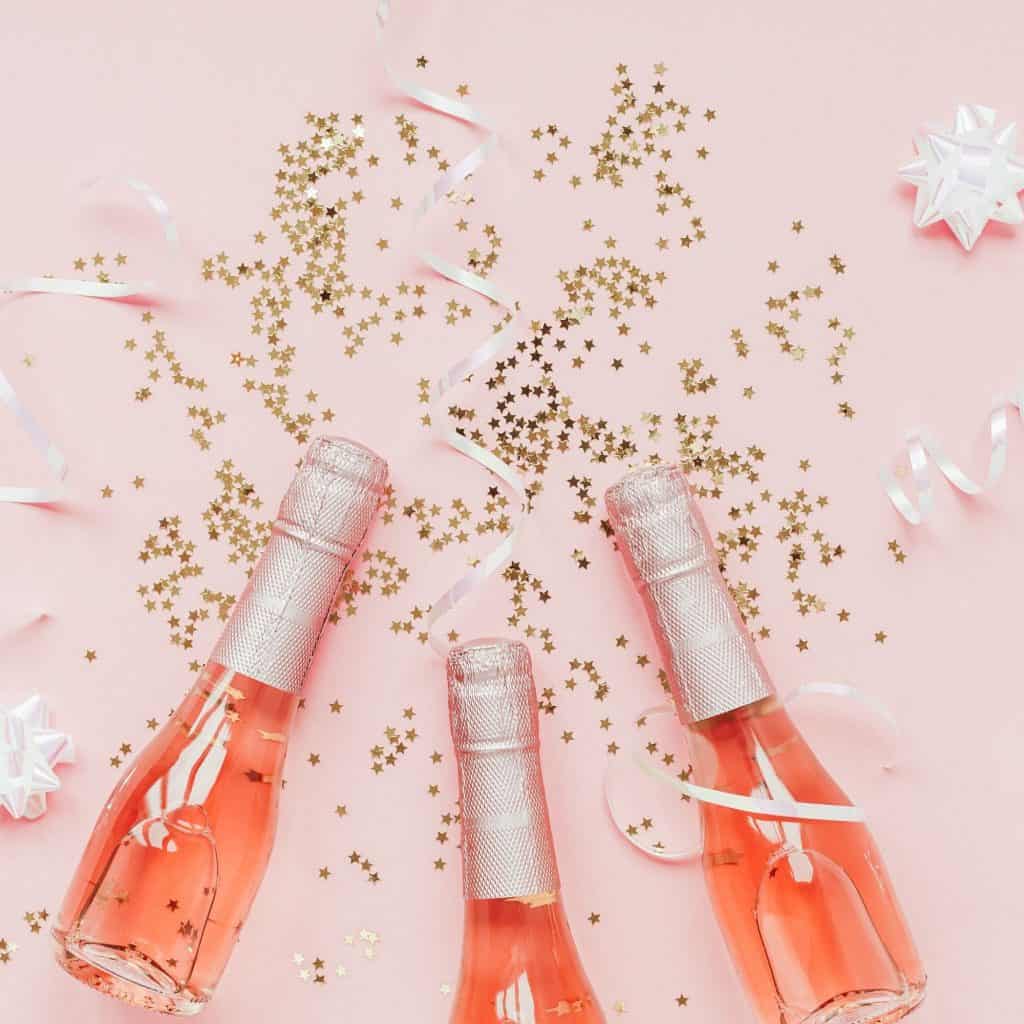mini pink champagne bottles with gold confetti