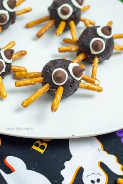 chocolate donut holes with pretzel legs and chocolate chip eyes to make spider snack idea
