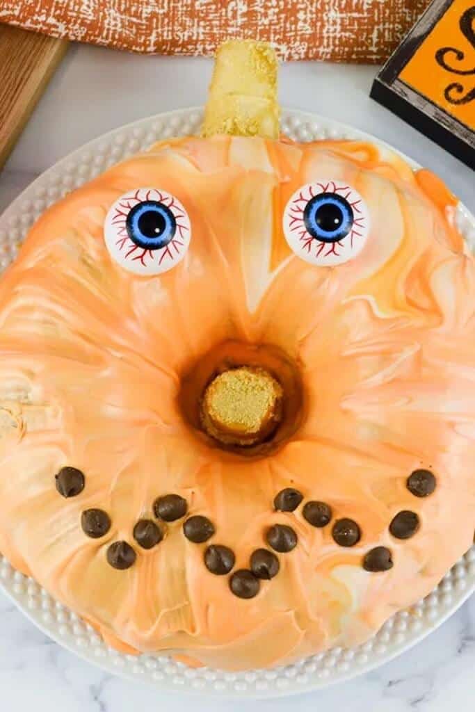 orange halloween pumpkin bundt cake decorated like a jackolantern