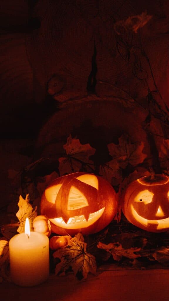 halloween wallpaper background image consisting of lit jack o lantern and candles