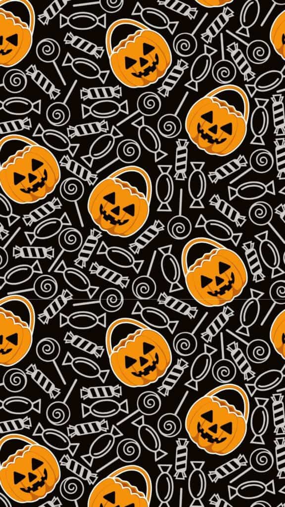 halloween wallpaper background image consisting of halloween candy doodles and jack o lantern candy basket on black backdrop