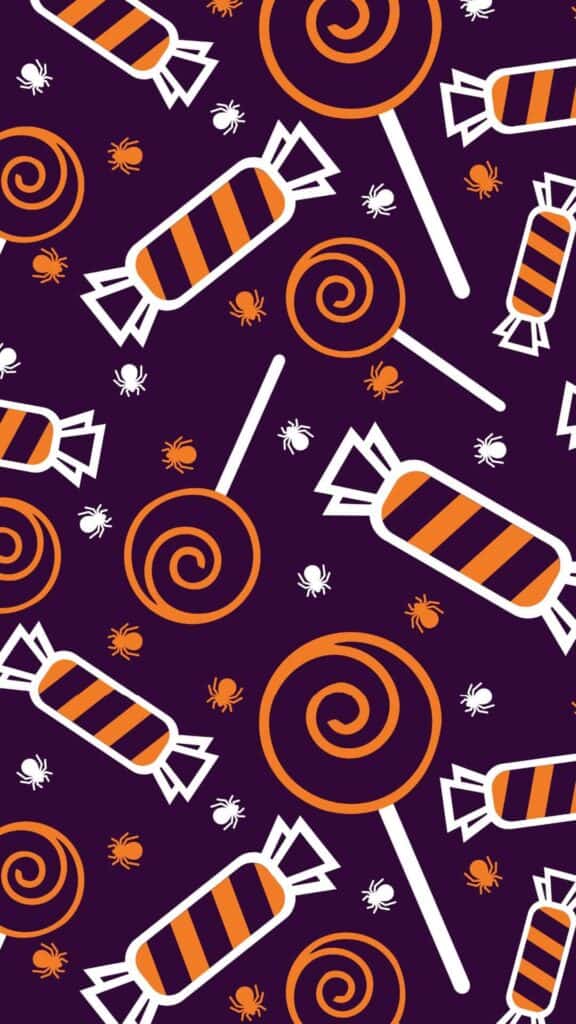 halloween wallpaper background image consisting of orange and white halloween candy on purple backdrop